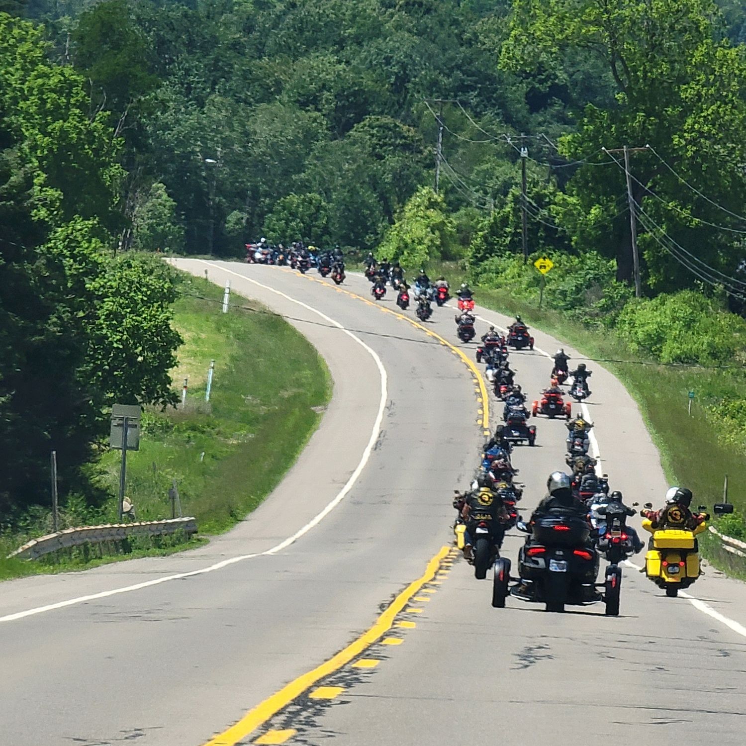 Motorcycle riders and members of the Combat Vets Motorcycle Association move together down the road in staggered formation to raise awareness for Veteran Suicide.