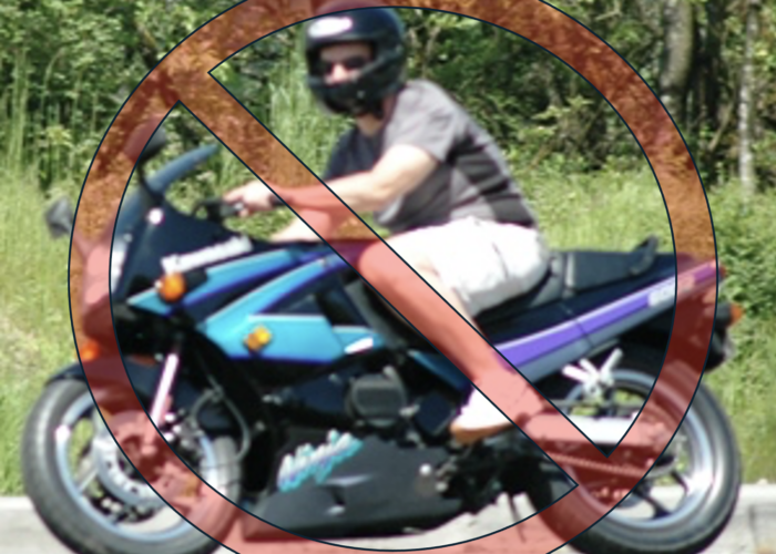 Motorcycle rider wearing shorts and a t-shirt