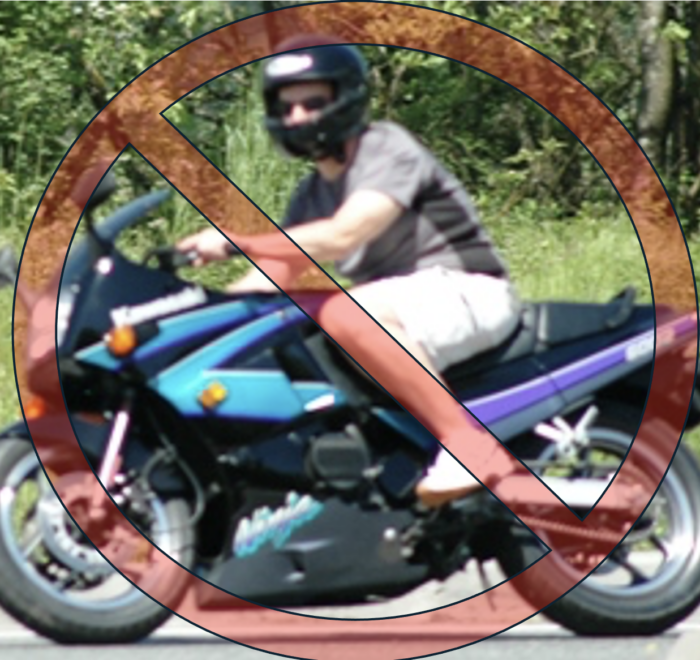 Motorcycle rider wearing shorts and a t-shirt